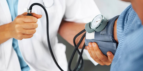 Doctor checking blood pressure