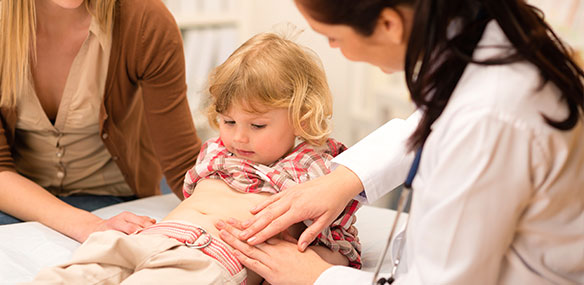 Doctor examining child's stomach