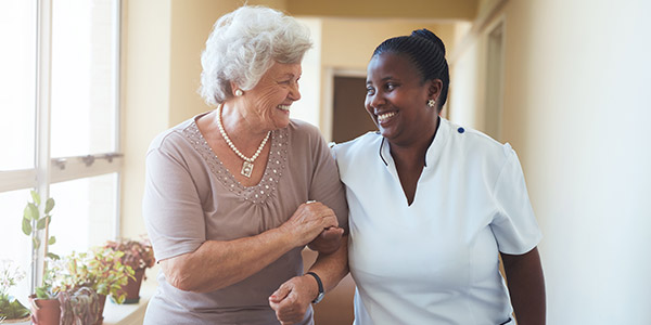 Smiling caregiver and woman