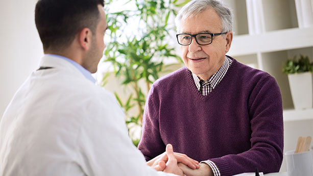 Older man talking with doctor