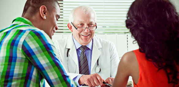 Young Hispanic couple consulting with doctor at doctor's office