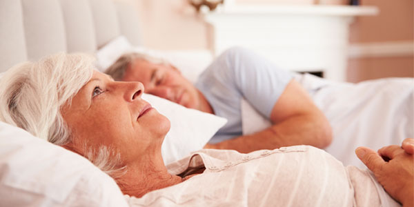 Middle-aged woman sleepless in bed