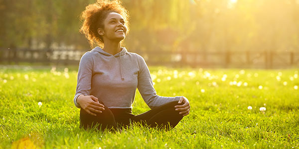 Young girl sitting in sunny grass