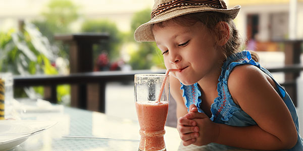 Little girl drinking smoothie